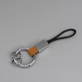 Porte-clés minimaliste en cuir marron avec cordon noir et anneaux en métal argenté - Orange + Argent
