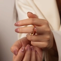 Golden eternity ring with emerald-cut orange zircons worn on a finger - Style A Orange Red