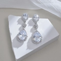 Pear cut clear cubic zirconia drop earrings with three-tier halo design in gold finish - White Zircon