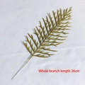 Detail of 36cm sparkling gold glitter leaf spray for festive holiday home decoration - Symmetrical Leaf
