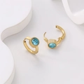Close-up of 18K gold-plated stainless steel earrings with light blue zircon stones - Blue