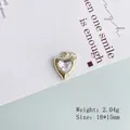 Macro detail of a 2.04g heart-shaped pendant with a 18x15mm lava texture design - 8# Gold Rhinestone Heart