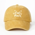 Detailed macro view of mustard yellow washed cotton fabric and Cat Mom embroidery - Yellow