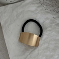 Irregular gold alloy metal ponytail holder with black elastic hair tie on white paper - 00621-Irregular Sheet-Gold