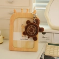 Brown plush turtle keychain with white textured shell hanging on a wooden frame - Brown Style (Style 31) / 10cm