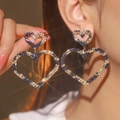 Macro shot of luxury heart drop earrings with black gold plating and sparkling crystals - Black Gold Double Heart Large Pendant Style (LDE1019BR-LE)