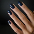 Glossy navy blue square press-on nails set shown on model hands with dark backdrop - Navy Blue