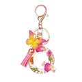 Pink resin letter Q keychain with dried flowers, butterfly charm and silk tassel - Flower Pattern Q