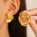 Detailed macro view of gold rose-shaped stud earrings with intricate metallic texture - 3D Rose Style (0936) / 29 Matt Gold