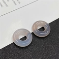 Detail view of two translucent lavender agate donut beads on a minimalist background - Grey Agate