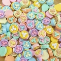 Macro shot of colorful mini resin fan-shaped nail art charms in assorted macaron tones - Fan