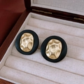 Detail view of retro oval stud earrings with black matte finish and gold hammered metal center - Black Gold Contrast Vintage Oval Style / Silver Earring Post - Alloy-Black