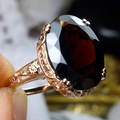 Vintage rose gold ring featuring a large oval red gemstone and floral relief engravings - US 6 / Red