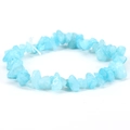 Macro detail of irregular light blue natural stone beads on a stretch elastic bracelet - Aquamarine