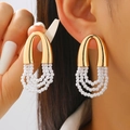 Elegant gold U-shaped earrings with triple-layered white pearl tassels on a female model - Gold U-Shape Multi-layer Pearl Earrings (7115)