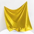 Detail shot of yellow satin fabric with smooth silk texture and glossy folds - 90*90cm / Yellow