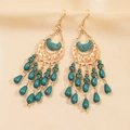 Close-up of bohemian earrings with turquoise beads and golden crescent moon engravings - Ear Hook - Green