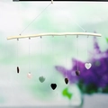 Natural crystal heart wind chime hanging on wooden branch with multi-colored stones - Heart Style