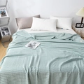 Detail of light green waffle weave cotton blanket on bed showing soft texture and drape - 200*230cm / Teal Blue