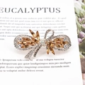 Elegant bow hair clip with amber rhinestones and rose gold plating on display card - Tassel / Champagne Gold