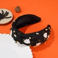 Detail eines Knotenstirnbands mit weißen Geistern und Diamanten auf orangefarbenem Grund - Halloween Geist Stirnband / Schwarz