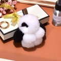 Plush black and white penguin charm with golden ring on warm orange surface - 8cm / White and Black