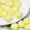 Macro shot of glossy yellow cat paw acrylic beads for DIY jewelry and crafts - Bright Yellow