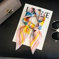 Pink satin square scarf with yellow floral and abstract print in a knotted style - 58 Square Scarves / 65