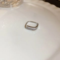 Minimalist silver zircon ring with square pattern on white wave ceramic plate background - Silver Square Channel Set Zirconia Style