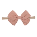Detail of baby bow headband in dusty rose cotton linen with jacquard dotted texture - Dried Rose