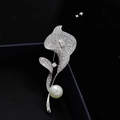 Macro shot of silver calla lily brooch featuring pavé crystals and a lustrous white pearl - Calla Lily Pearl / Silver Pearl