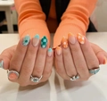 Macro view of checkered pattern and daisy design on press-on nails with bohemian rings - Yellow Jelly Glue + Nail File