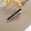 Navy blue crystal hair clip with golden base and sparkling rhinestones on magazine background - Rectangular Press Clip / Blue