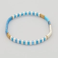 Handmade TILA bead elastic bracelet featuring blue, white, and golden metallic beads - Trans Blue/White/Gold