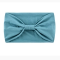 Elastic wide yoga headband in solid teal fabric featuring a stylish knotted bow design - Peacock Blue