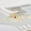 Golden evil eye coin pendant with pink zircon and radiant engraved sunbeam pattern - Rose Red Zirconia