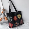 Detail of black canvas tote bag with hand-painted colorful flower illustrations - Six Flowers Black Bag