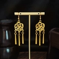 Bohemian gold-tone floral drop earrings with cylindrical tassels on a display stand - E6091-6 Hollow Camellia Cylindrical Tassel
