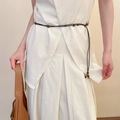 Detailed view of dark brown pearl beaded waist belt styled on an elegant off-white suit - Coffee Multi-strand Cord Beaded Waist Chain