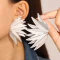 Macro shot of silver oversized leaf earrings featuring detailed wrinkled metal textures - Radial Wing Shape (N-366) / Silver
