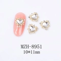 Detailed macro view of 10x11mm hollow heart alloy nail art charms with crystals - Gold Base Clear Rhinestone Style (8951)