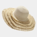 Close-up of beige wide-brim straw hat featuring tiered fringed edges and woven texture - One Size / Beige
