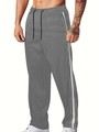 Détail du pantalon de sport en velours gris foncé avec bandes latérales blanches et cordon - Gris