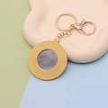 Close-up of yellow PU leather heart keychain with mirror and gold metal ring - Round Yellow