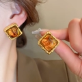 Close-up of vintage gold-plated square earrings with amber resin and hammered metal texture - Hammered Square Studs (33#) / Gold Amber