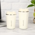 White stainless steel coffee mug with beige lid and COFFEE text on marble table - Normal Lid White