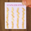 Golden star-shaped stainless steel earrings set arranged on white card display - KC Gold Star (A-1226)