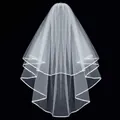 Elegant white two-tier bridal veil with satin ribbon edge trim against black background - Off White