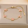 Detail of gold butterfly bracelet with pink enamel charms on luxury jewelry display box - Pink (KB187206-BI)