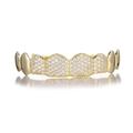 Macro shot of gold hip hop grillz featuring micro-paved white zircons and mirror reflection - Gold (Top Teeth)